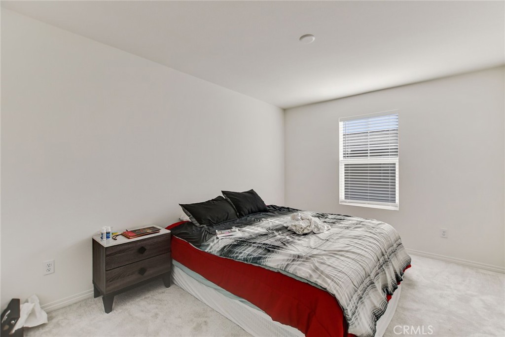 2526 Gunner Ridge Way Rialto, CA 92377 - Photo 23 of 33 a bed sitting in a bedroom next to a window
