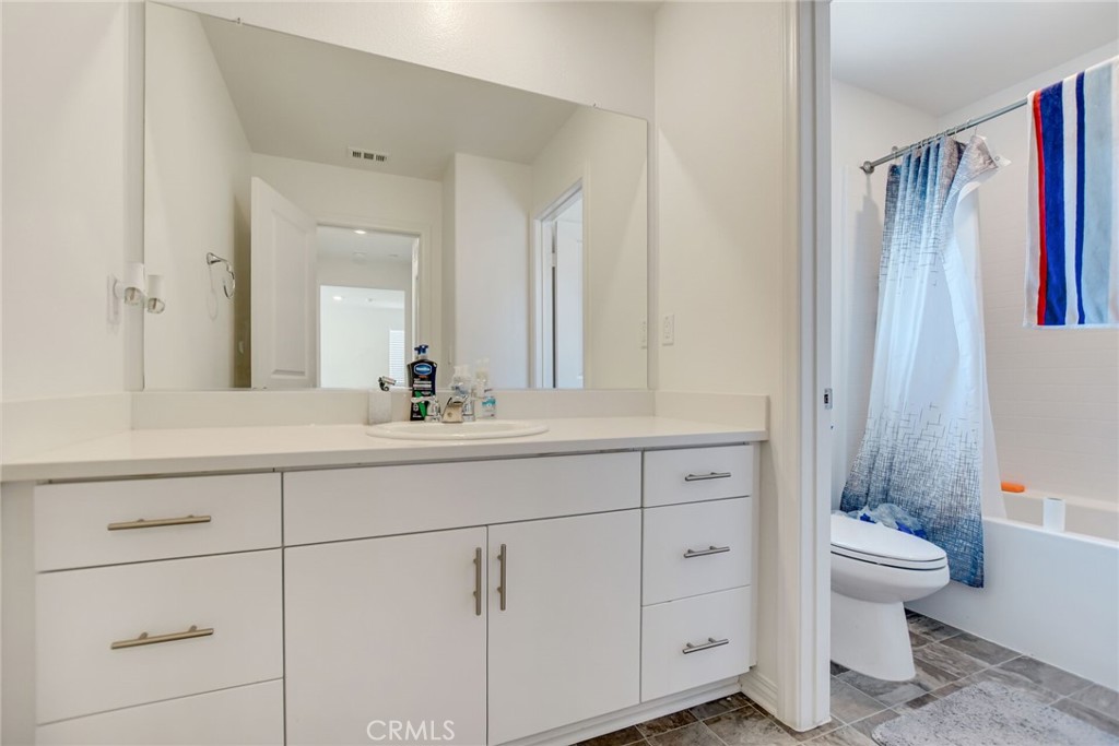 2526 Gunner Ridge Way Rialto, CA 92377 - Photo 24 of 33 a bathroom with a double vanity sink toilet and shower