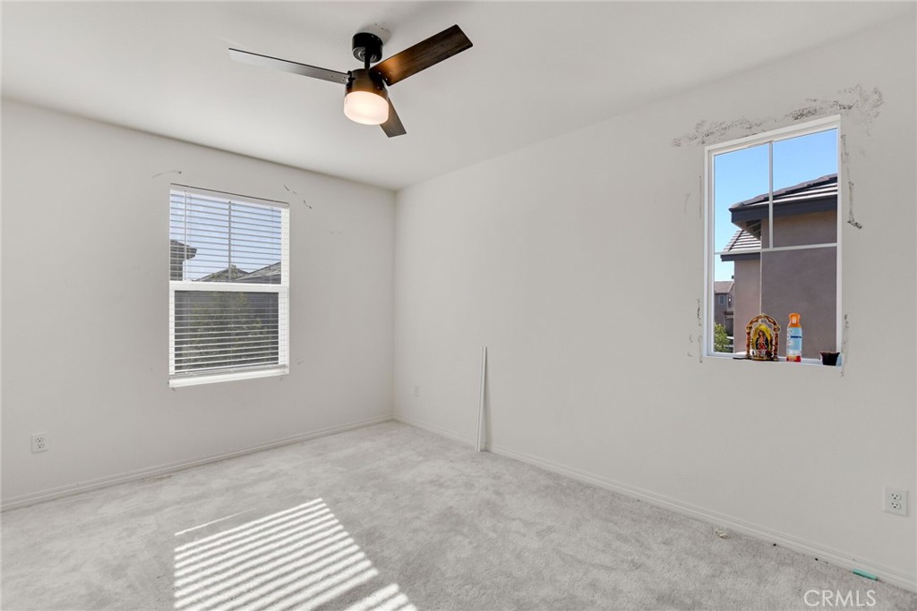 2526 Gunner Ridge Way Rialto, CA 92377 - Photo 25 of 33 an empty room with windows and fan