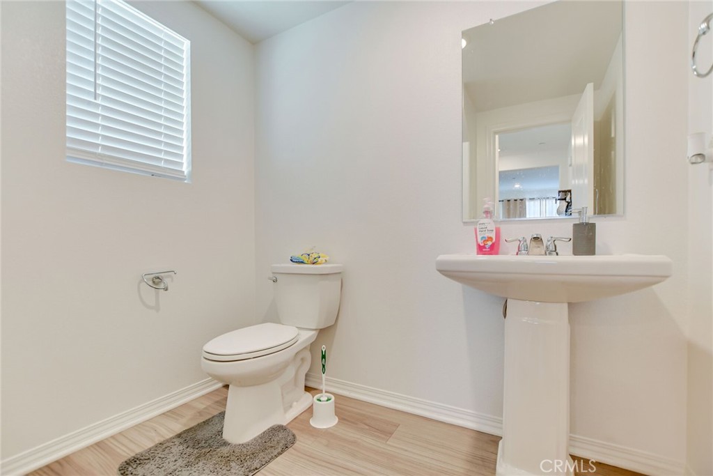 2526 Gunner Ridge Way Rialto, CA 92377 - Photo 27 of 33 a bathroom with a sink toilet and a mirror