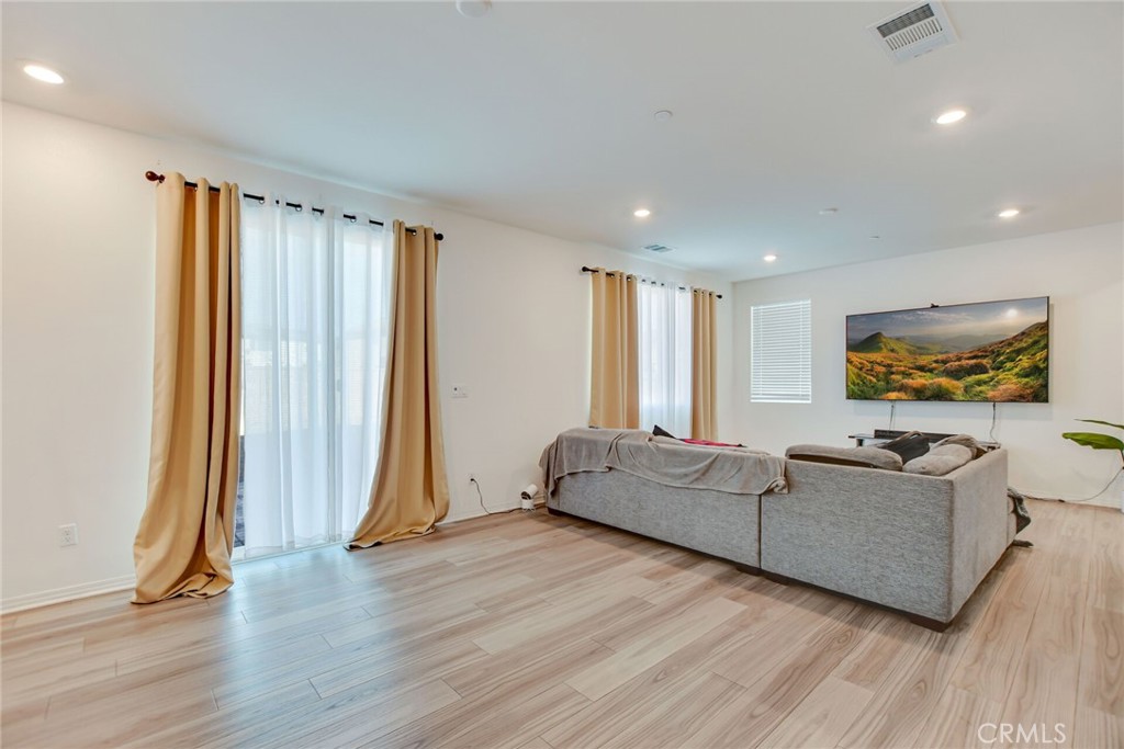 2526 Gunner Ridge Way Rialto, CA 92377 - Photo 6 of 33 a living room with furniture and a flat screen tv