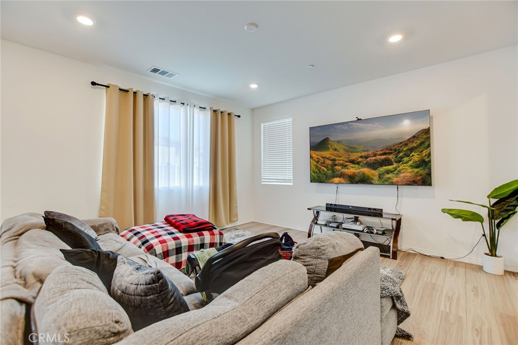 2526 Gunner Ridge Way Rialto, CA 92377 - Photo 7 of 33 a living room with furniture and a flat screen tv