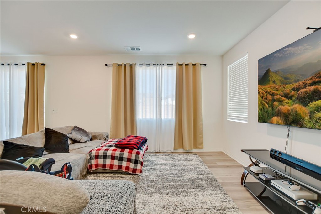 2526 Gunner Ridge Way Rialto, CA 92377 - Photo 10 of 33 a bedroom with a bed and wooden floor