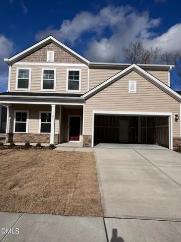 a front view of a house with yard