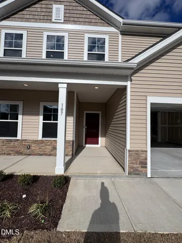 a kitchen with kitchen island a stove a sink a refrigerator and cabinets