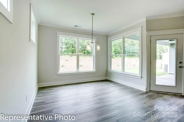 a view of a room window and wooden floor