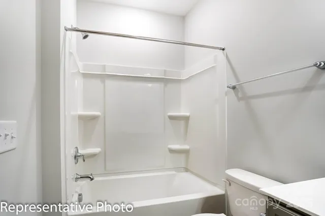 a bathroom with a shower and a toilet