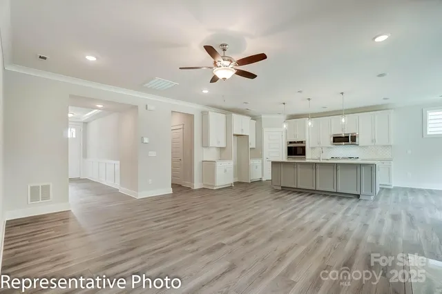 a view of an empty room with a kitchen