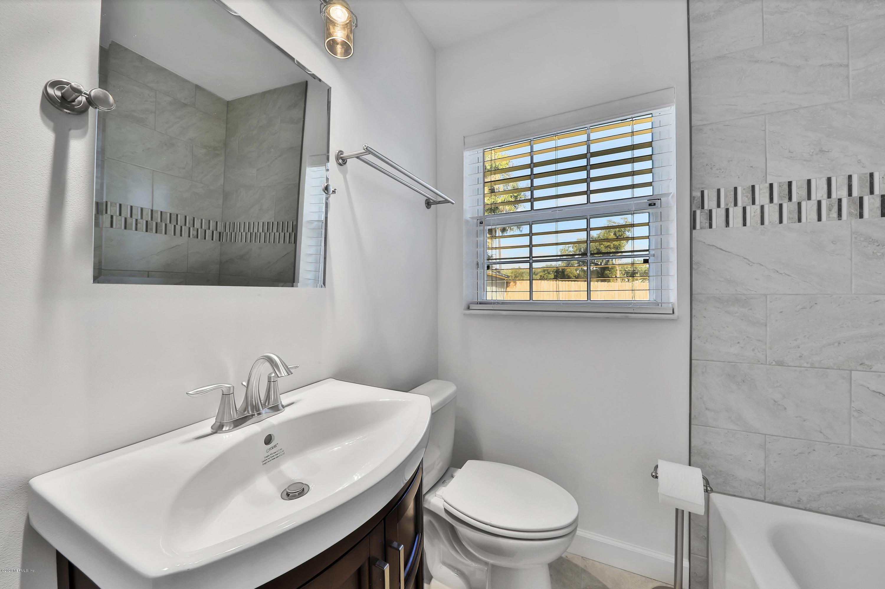1705 Furman Road Jacksonville, FL 32217 - Photo 17 of 23 a bathroom with a sink a toilet and a mirror