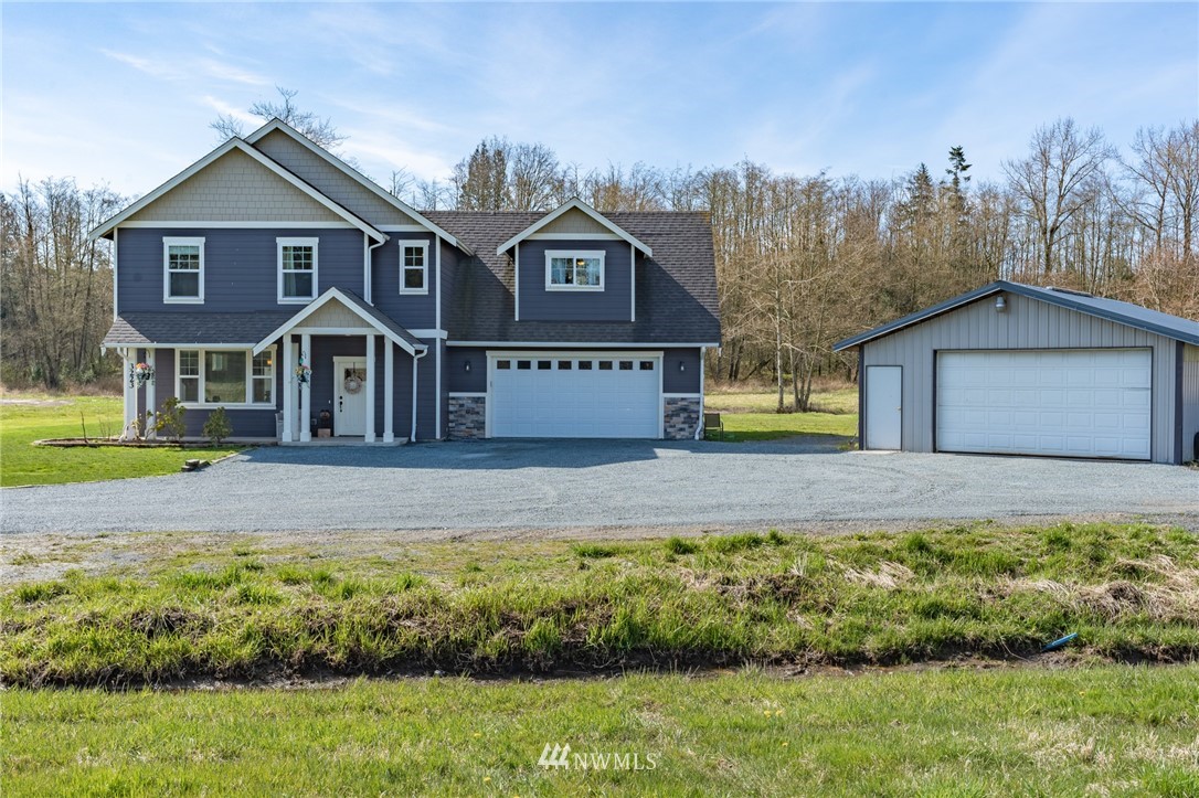 3223 Brown Road Ferndale, WA 98248 - Photo 1 of 40 a front view of a house with a garden
