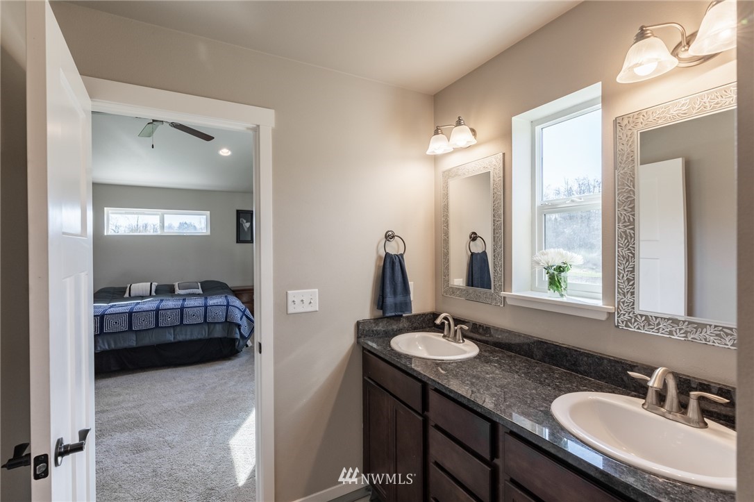 3223 Brown Road Ferndale, WA 98248 - Photo 22 of 40 a en suite bathroom with a granite countertop sink and a mirror