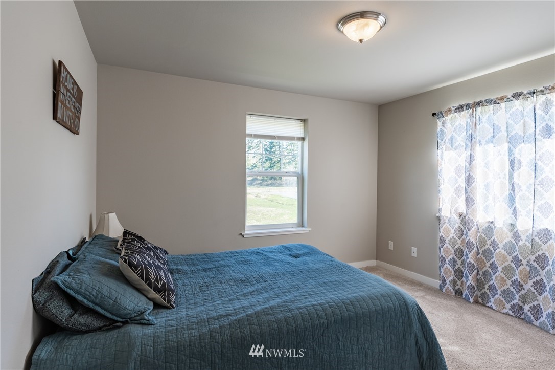 3223 Brown Road Ferndale, WA 98248 - Photo 23 of 40 a bedroom with a bed and a window