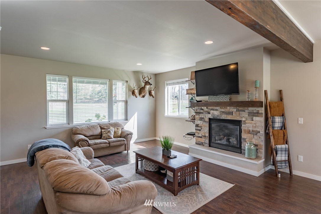 3223 Brown Road Ferndale, WA 98248 - Photo 4 of 40 a living room with furniture a flat screen tv and a fireplace