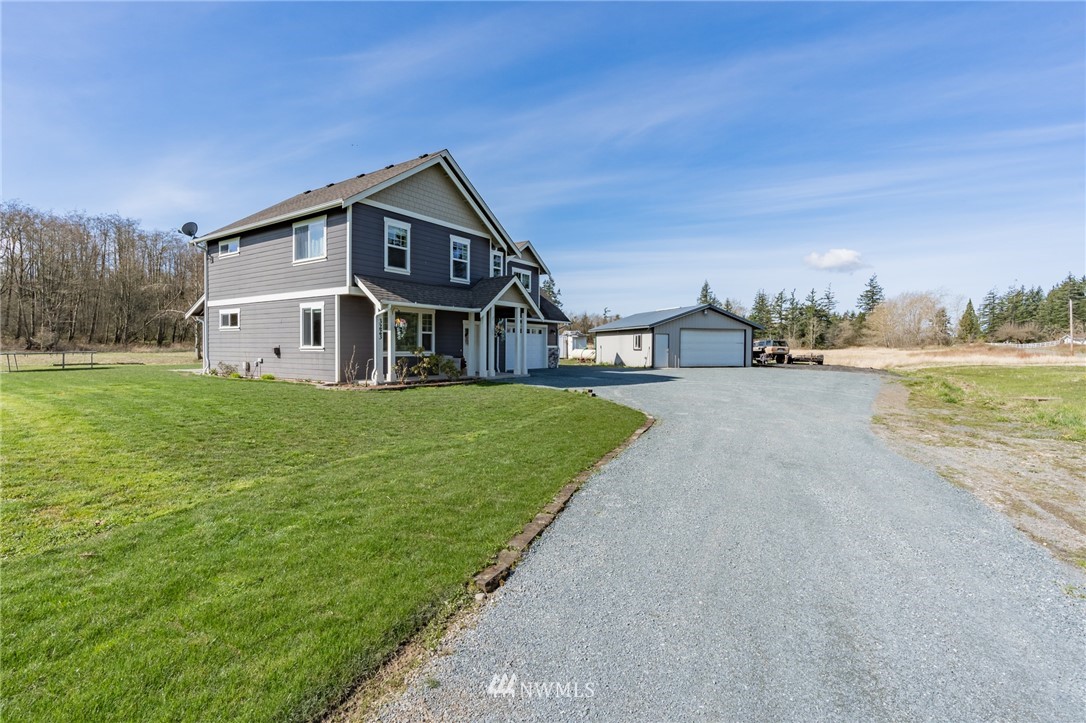 3223 Brown Road Ferndale, WA 98248 - Photo 40 of 40 a view of a house with a big yard and large trees