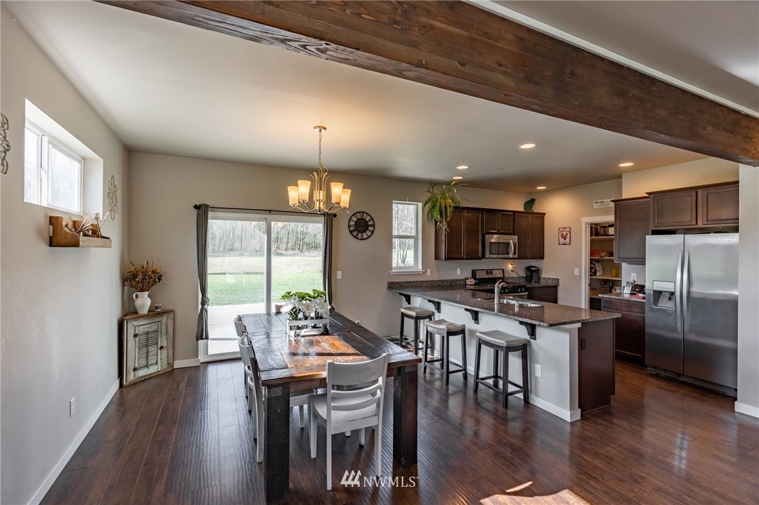 3223 Brown Road Ferndale, WA 98248 - Photo 10 of 40 a view of a dining room with furniture window and wooden floor