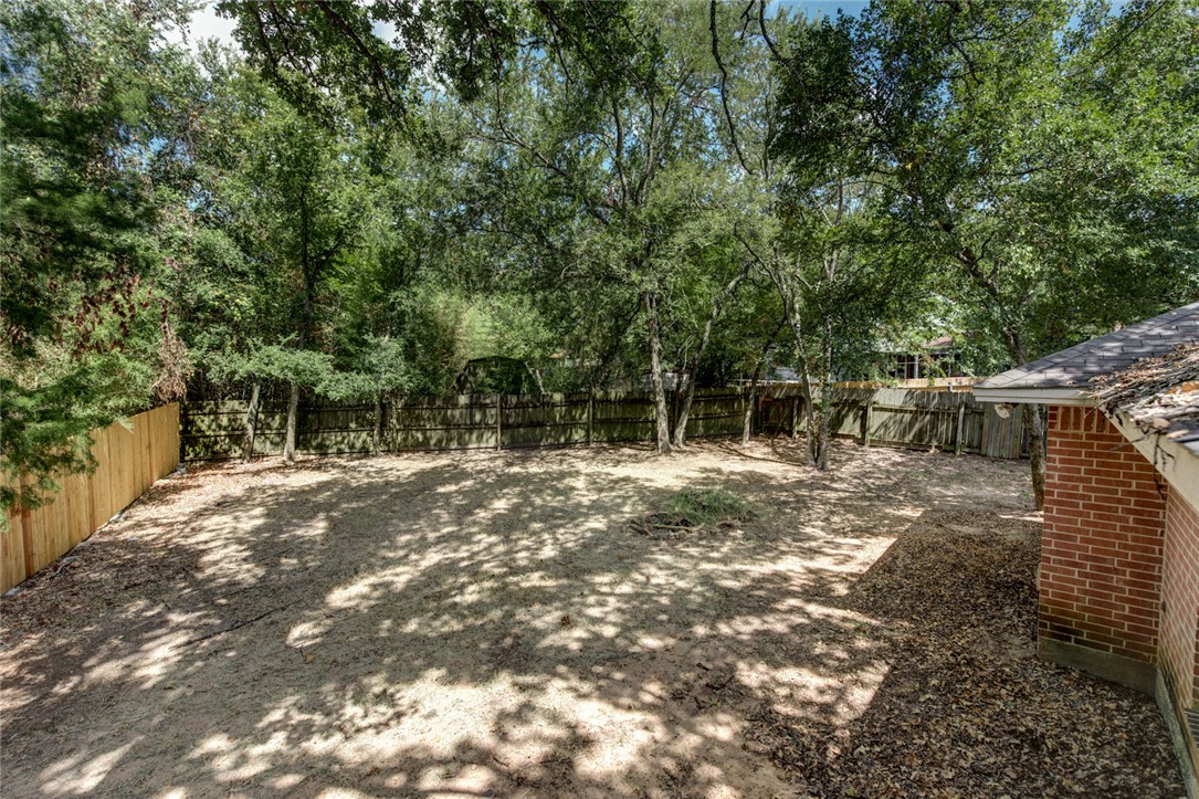 2402 Jaguar Court Bryan, TX 77807 - Photo 16 of 19 a backyard of a house with lots of green space