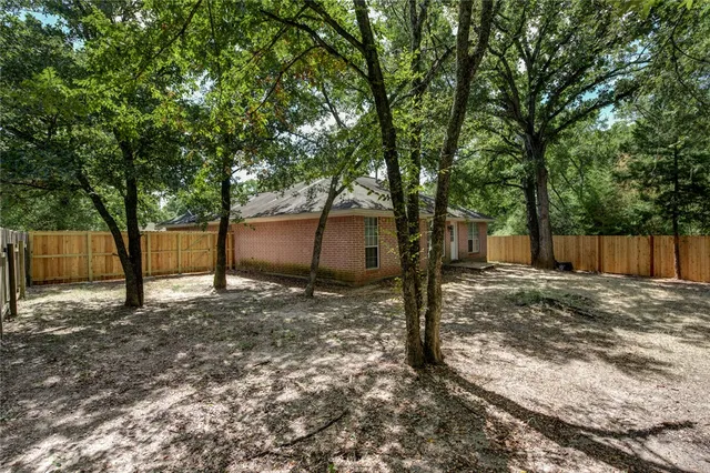 a backyard of a house with a tree