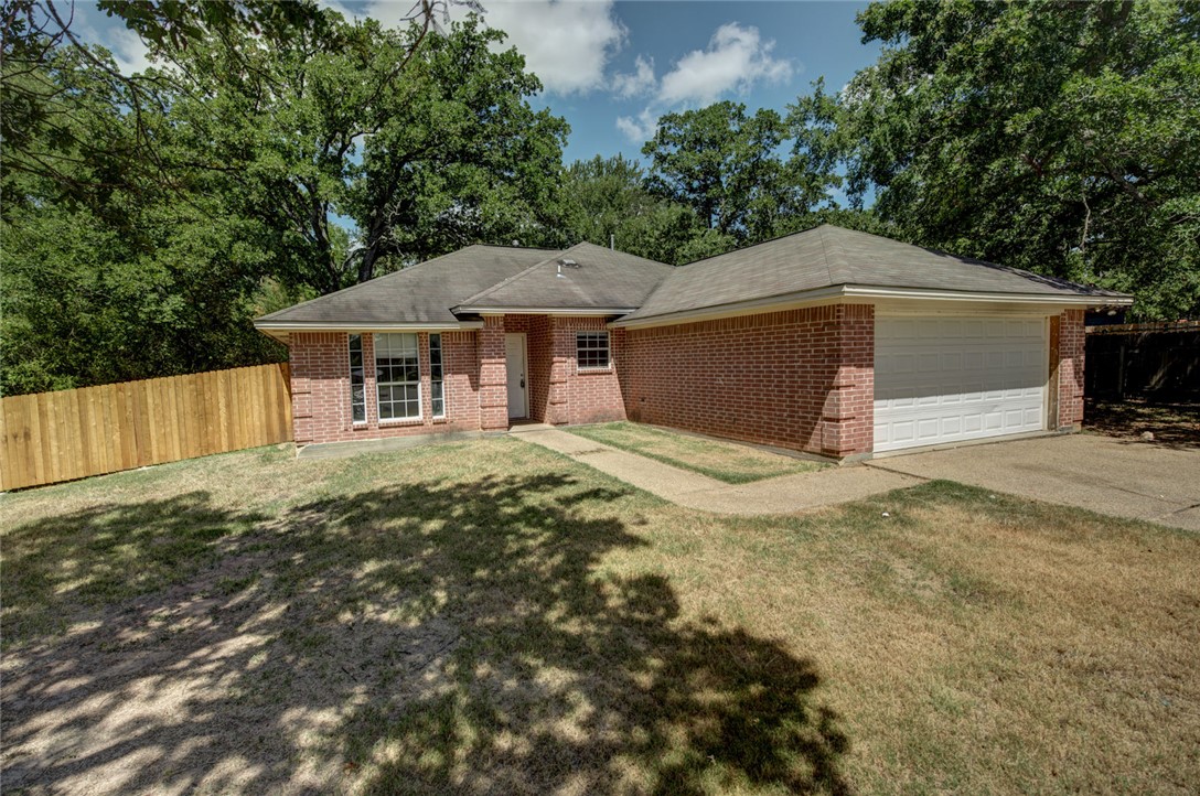 2402 Jaguar Court Bryan, TX 77807 - Photo 19 of 19 a house with trees in the background