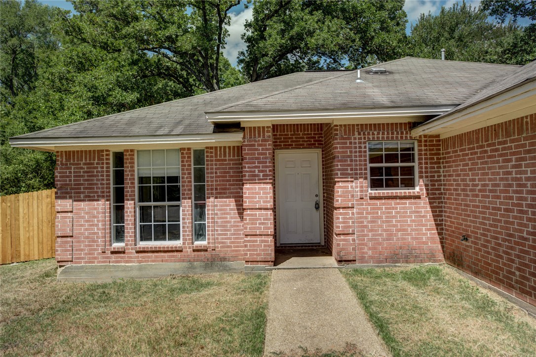 2402 Jaguar Court Bryan, TX 77807 - Photo 2 of 19 a front view of a house with a garden