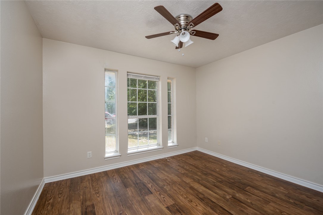 2402 Jaguar Court Bryan, TX 77807 - Photo 4 of 19 an empty room with wooden floor and windows