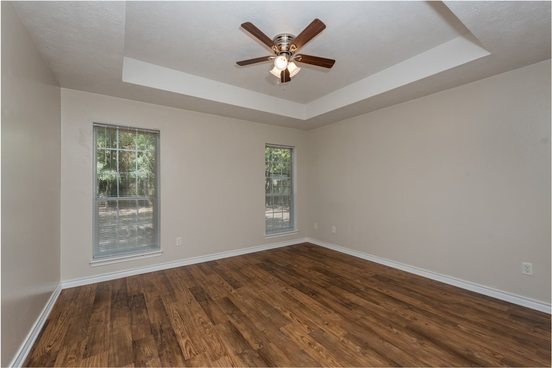 2402 Jaguar Court Bryan, TX 77807 - Photo 6 of 19 an empty room with wooden floor and windows