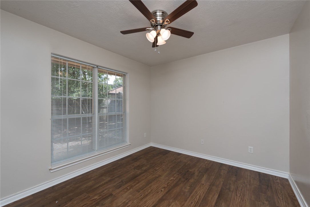 2402 Jaguar Court Bryan, TX 77807 - Photo 7 of 19 wooden floor in an empty room with a window