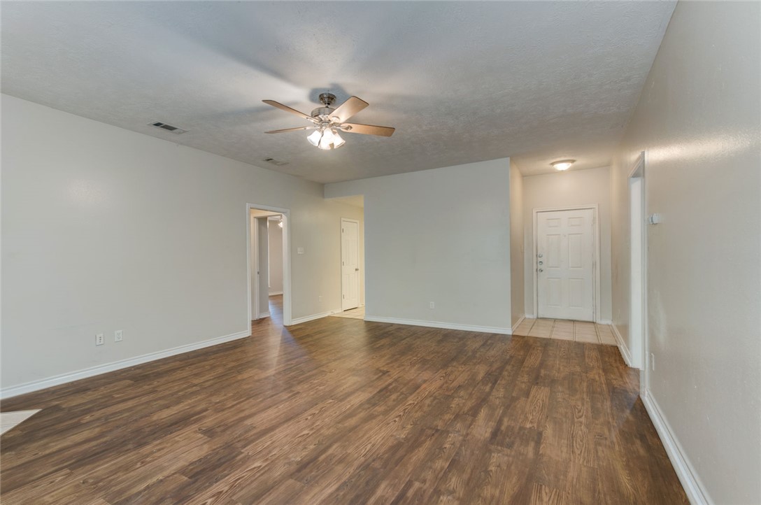 2402 Jaguar Court Bryan, TX 77807 - Photo 9 of 19 a view of an empty room with wooden floor