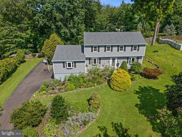 an aerial view of a house with yard and green space