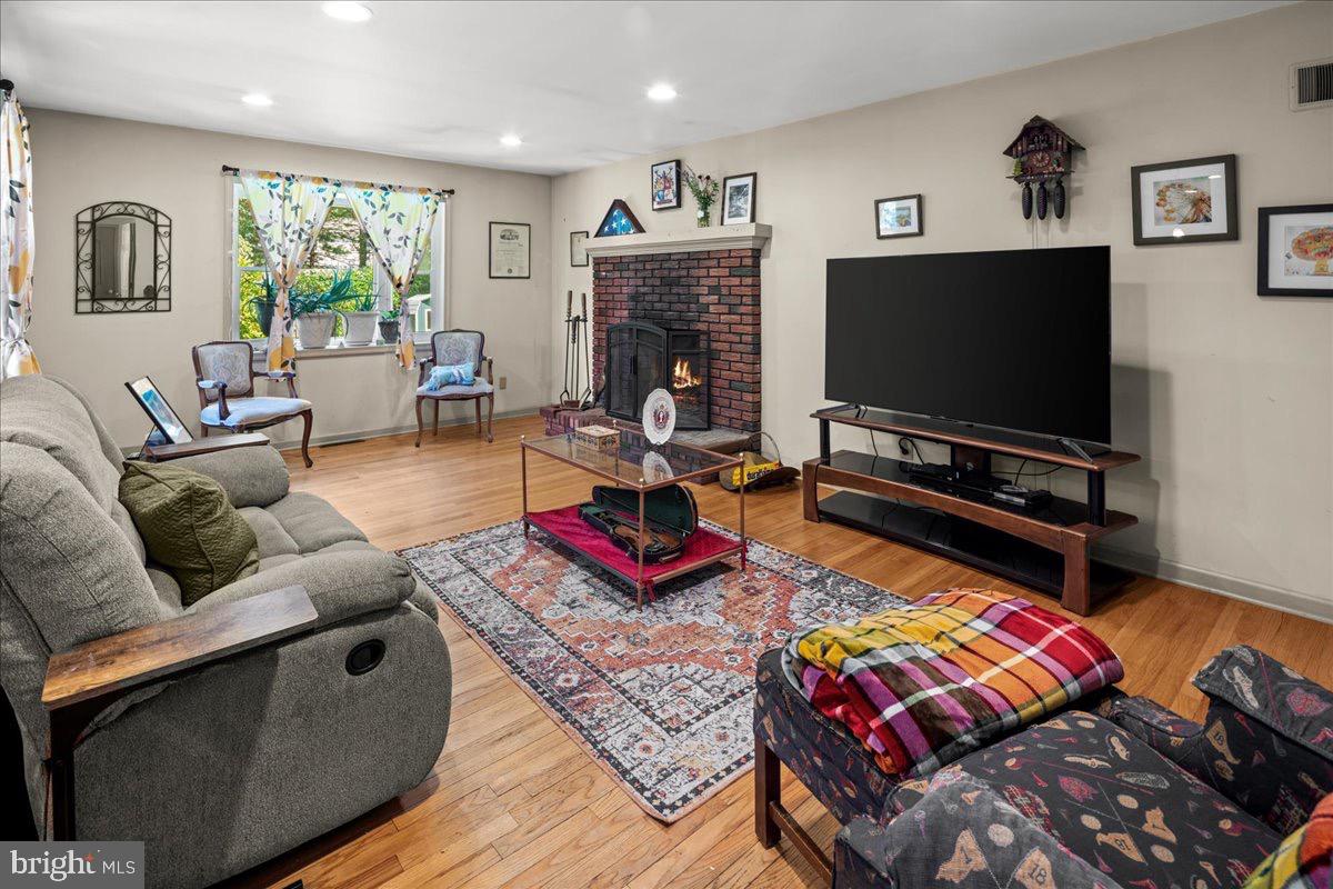 20 Bernard Drive Ewing, NJ 08628 - Photo 15 of 44 a living room with furniture a flat screen tv and a fireplace