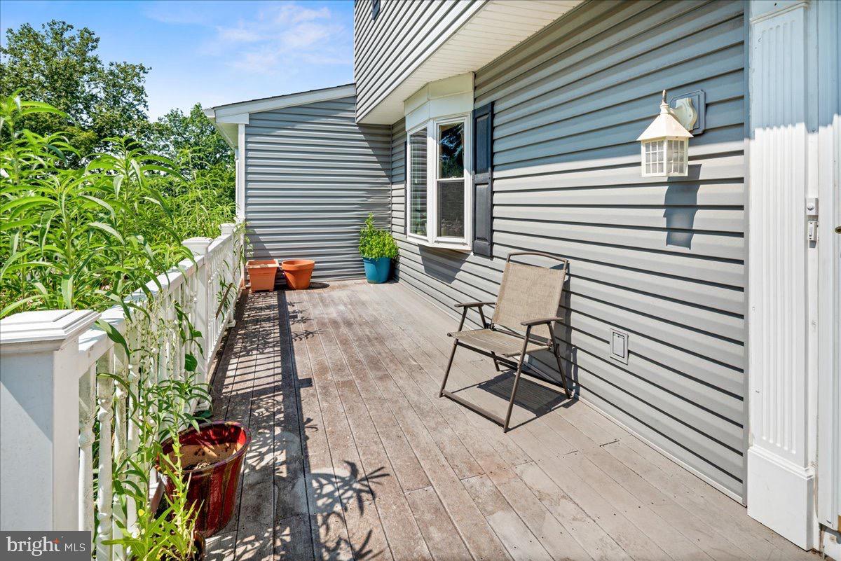 20 Bernard Drive Ewing, NJ 08628 - Photo 33 of 44 a view of a patio with chair and table and chairs and potted plants