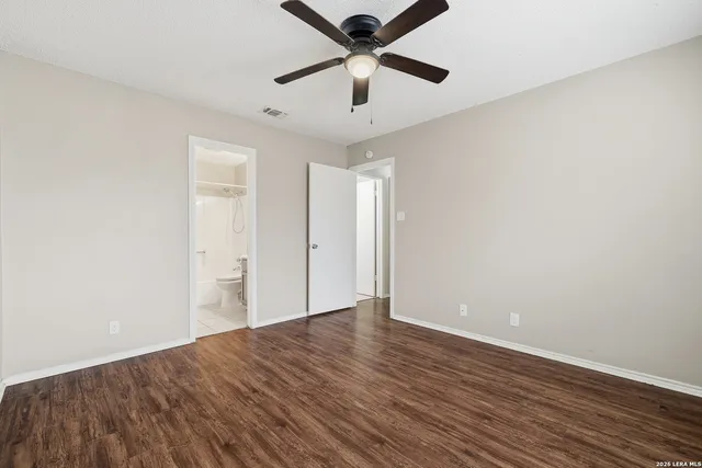 a view of an empty room with wooden floor