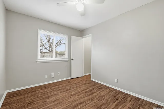 wooden floor in an empty room with a window