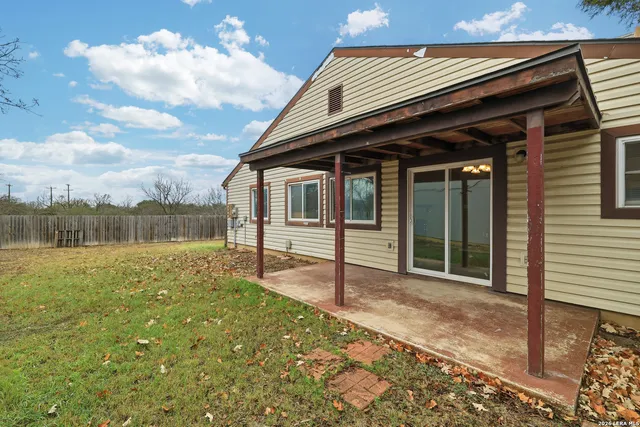 a backyard of a house with lots of green space and lake view