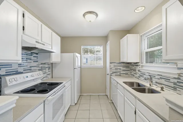 a kitchen with a stove sink and refrigerator