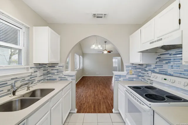 a kitchen with a stove and a sink