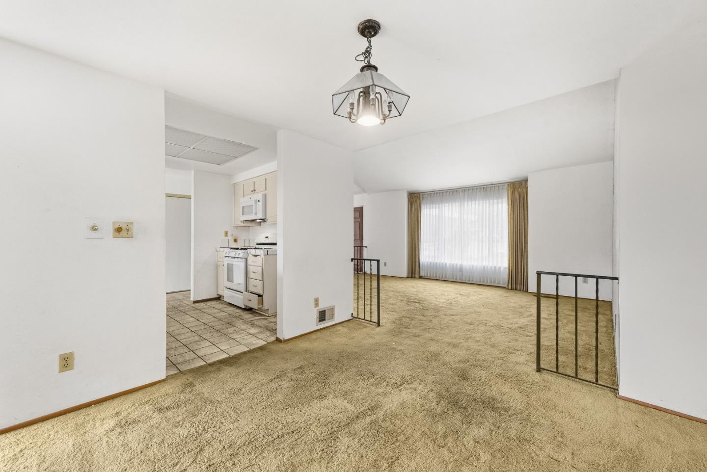 45811 Cheyenne Place Fremont, CA 94539 - Photo 16 of 44 an empty room with chandelier fan and windows