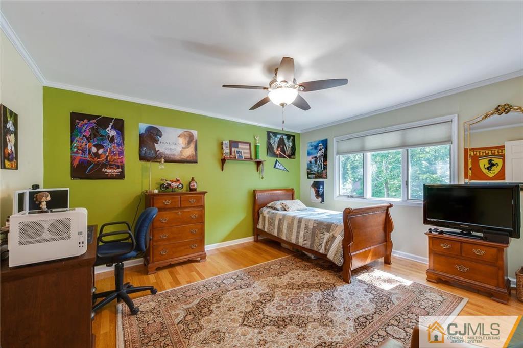 16 Timber Road East Brunswick, NJ 08816 - Photo 22 of 31 a bedroom with furniture and a flat screen tv