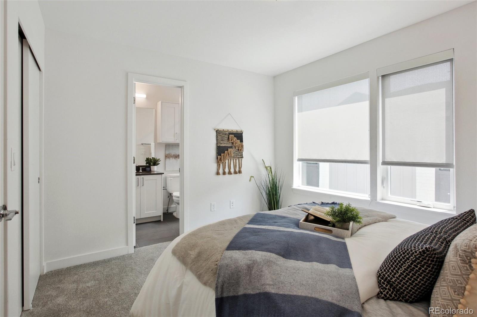 8705 Ralston Road Arvada, CO 80002 - Photo 16 of 16 a bedroom with a bed a couch and a window