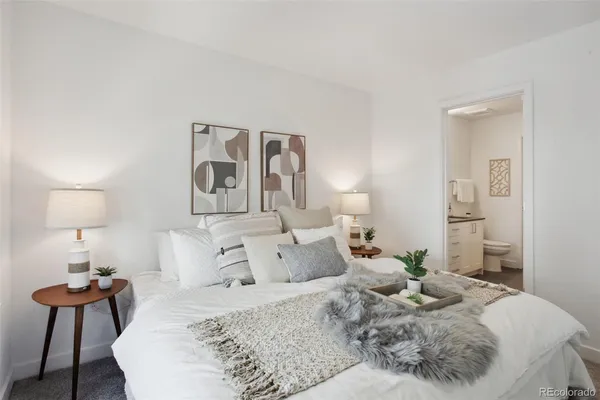 a bedroom with a bed and a lamp