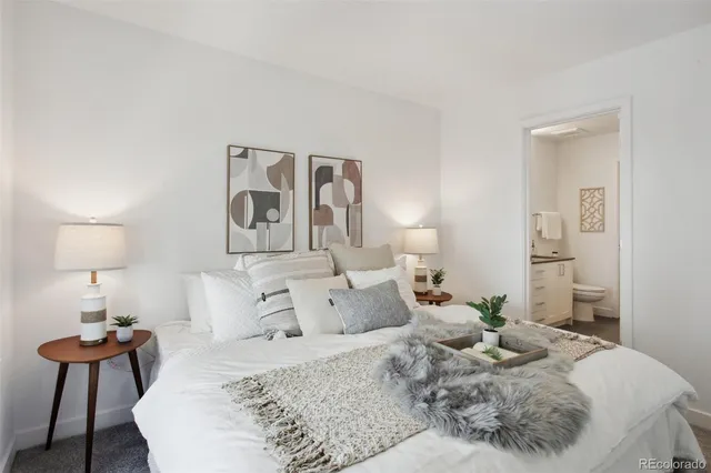 a bedroom with a bed and a lamp