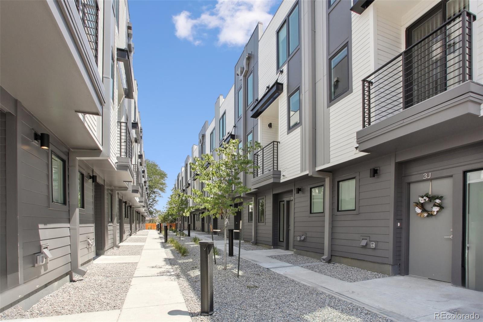 8705 Ralston Road Arvada, CO 80002 - Photo 9 of 16 a view of a pathway along the building