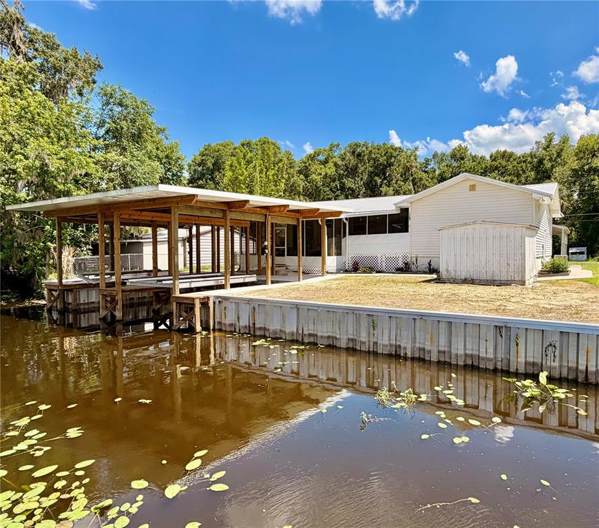 24521 Alligator Road Astor, FL 32102 - Photo 51 of 51 swimming pool view with a seating space and a garden view