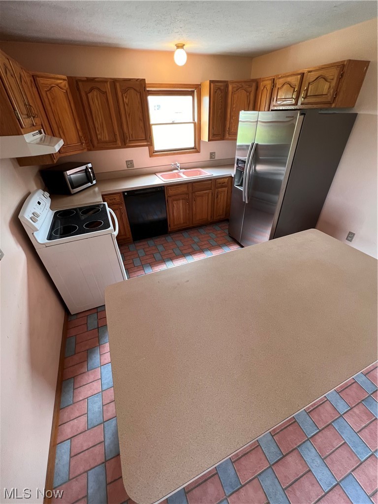 5435 Columbia Road Medina, OH 44256 - Photo 9 of 30 Kitchen with sink, light tile flooring, countertops light, fridge, and dishwasher