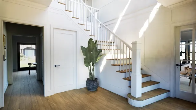 a view of entryway with wooden floor and stairs