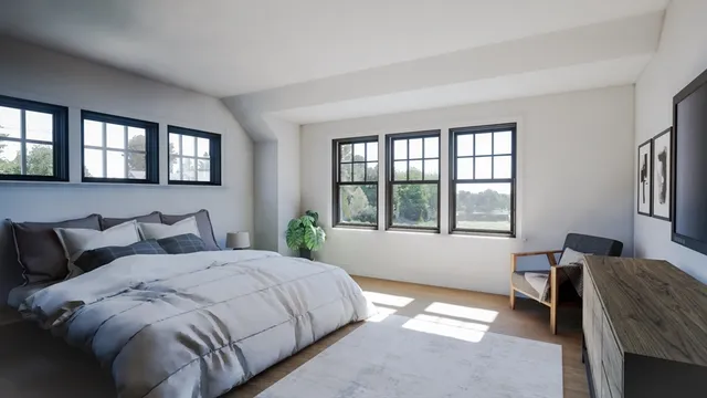 a living room with furniture and a large window with wooden floor