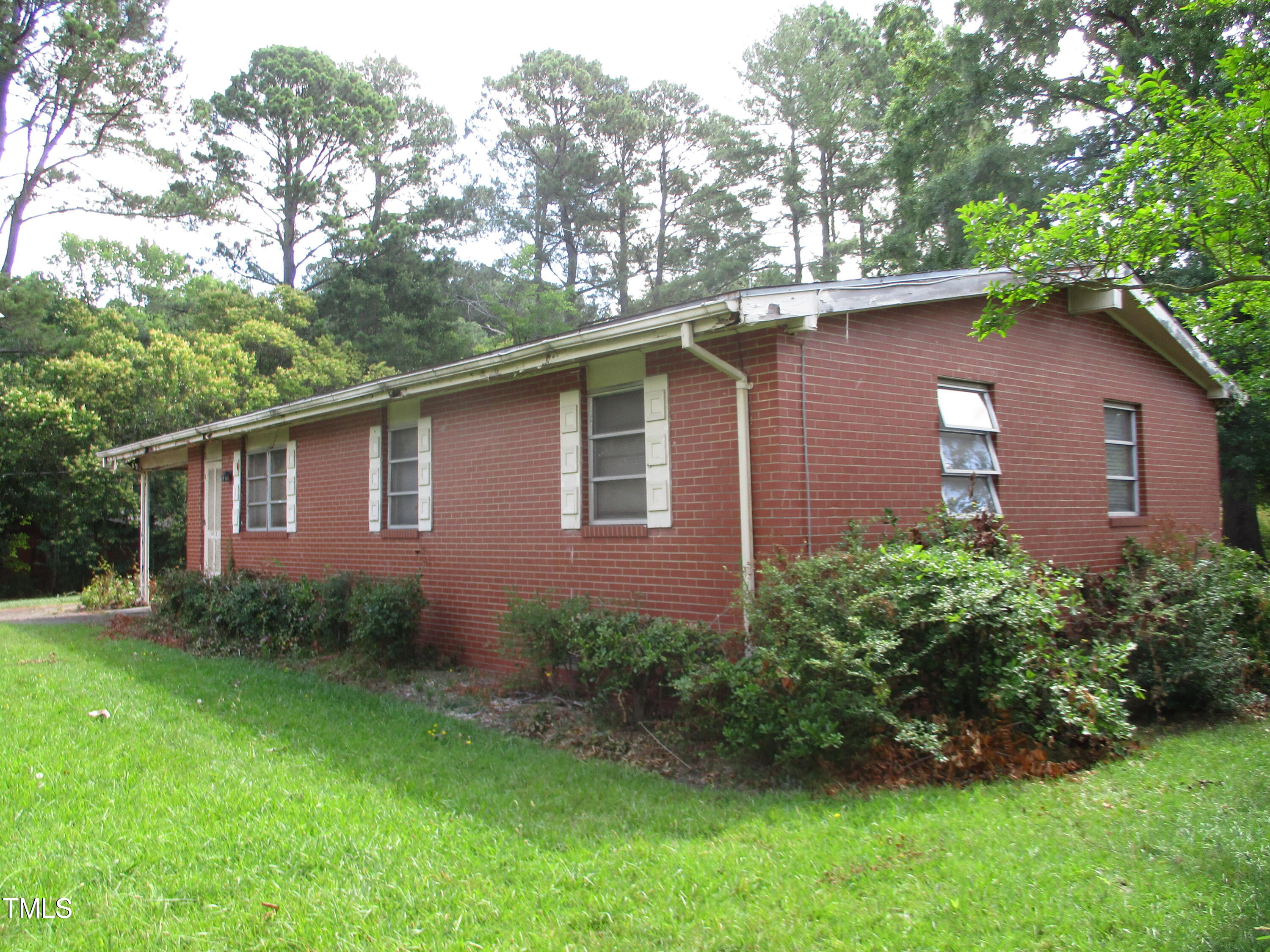 1432 Cross Link Road Raleigh, NC 27610 - Photo 1 of 16 a backyard of a house with lots of green space
