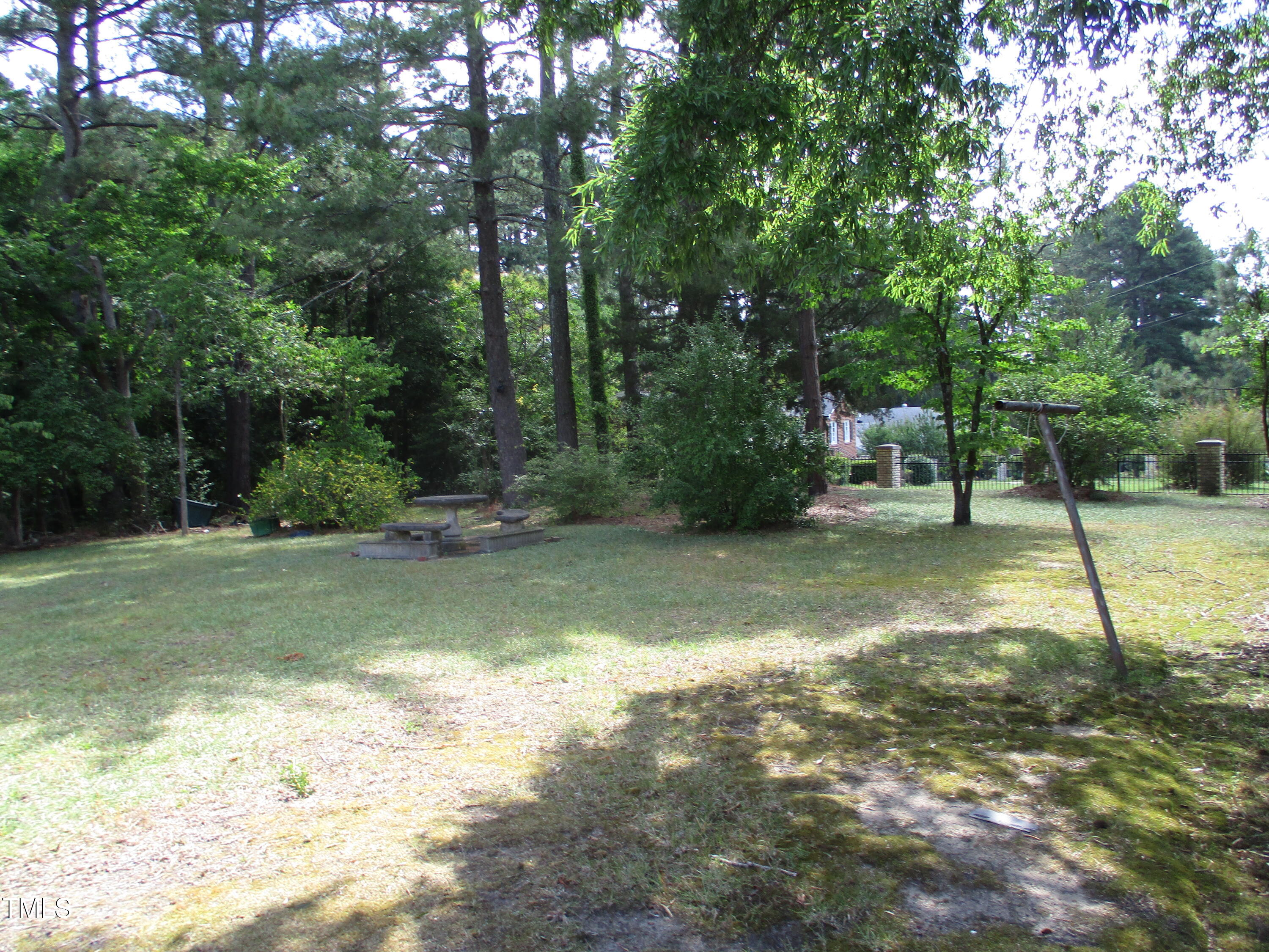 1432 Cross Link Road Raleigh, NC 27610 - Photo 11 of 16 a view of a yard with a tree