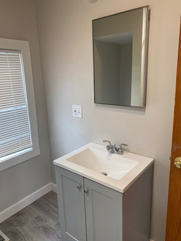 66 R Foster Street, Unit 66 Boston, MA 02135 - Photo 2 of 9 a bathroom with a sink and a mirror