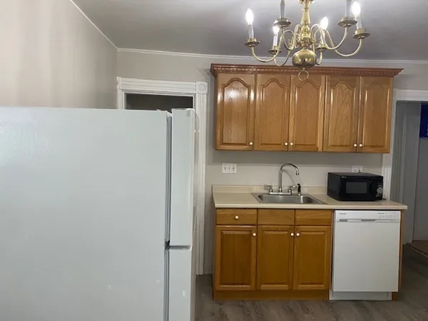 a view of a kitchen with a sink cabinets and stainless steel appliances