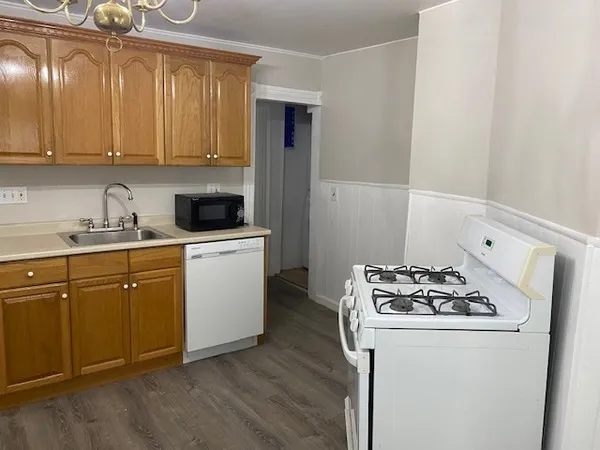a kitchen with a sink a stove and cabinets